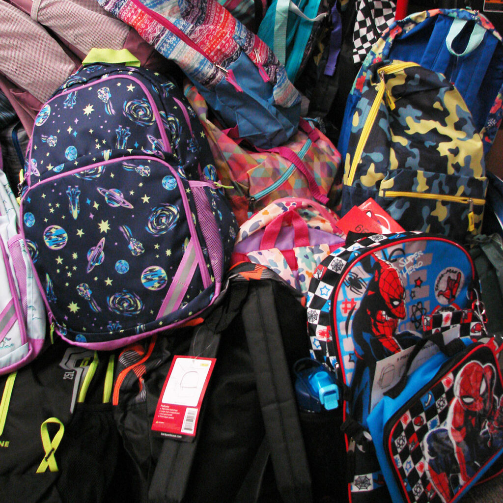 pile of colorful children's backpacks